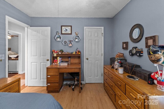 716 Mooresville Rd, Salisbury, NC 28144 - bedroom featuring light wood finished floors, an office area, and a textured ceiling
