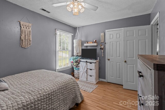 716 Mooresville Rd, Salisbury, NC 28144 - bedroom with a textured ceiling, wood finished floors, and ceiling fan