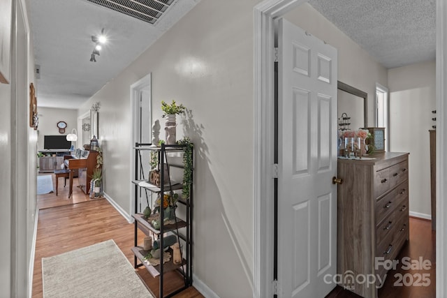 716 Mooresville Rd, Salisbury, NC 28144 - hallway with wood finished floors, baseboards, and a textured ceiling