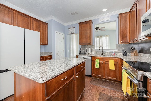 411 Summergate Dr Unit 78, Winston Salem, NC 27103 - kitchen featuring appliances with stainless steel finishes, dark wood finished floors, a sink, light stone counters, and decorative backsplash