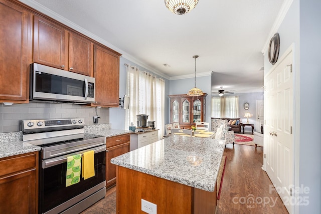 411 Summergate Dr Unit 78, Winston Salem, NC 27103 - kitchen featuring stainless steel appliances, open floor plan, ornamental molding, a center island, and dark wood-type flooring