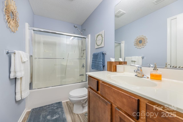 411 Summergate Dr Unit 78, Winston Salem, NC 27103 - bathroom with vanity, toilet, enclosed tub / shower combo, wood finished floors, and a textured ceiling