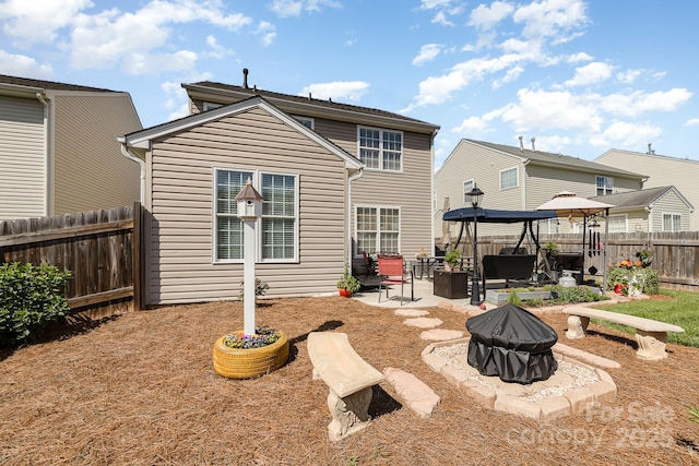 411 Summergate Dr Unit 78, Winston Salem, NC 27103 - rear view of property featuring a fenced backyard, an outdoor fire pit, a patio area, and a gazebo