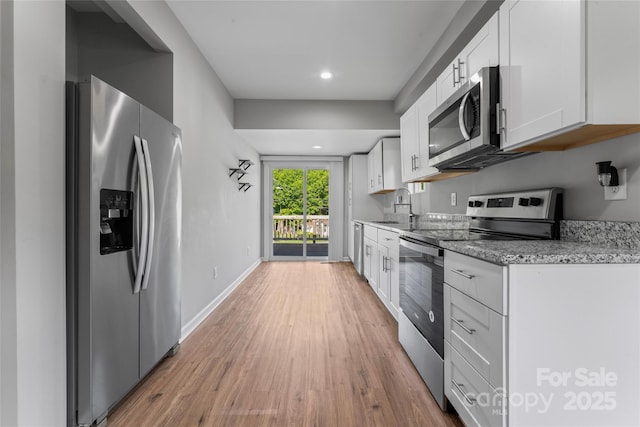 146 Georgia St SW, Concord, NC 28025 - kitchen with stainless steel appliances, light wood-style floors, white cabinets, light stone countertops, and recessed lighting