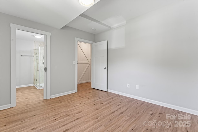 146 Georgia St SW, Concord, NC 28025 - unfurnished bedroom with baseboards and light wood finished floors