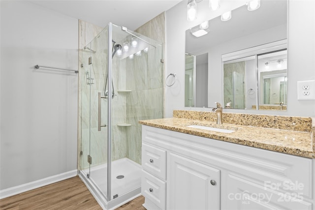 146 Georgia St SW, Concord, NC 28025 - bathroom featuring a stall shower, vanity, and wood finished floors