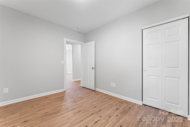 146 Georgia St SW, Concord, NC 28025 - unfurnished bedroom featuring light wood-type flooring and a closet