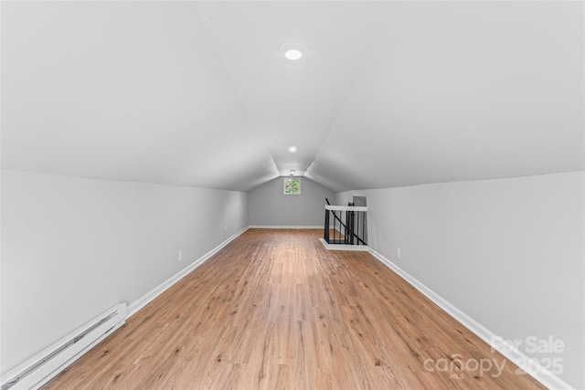 146 Georgia St SW, Concord, NC 28025 - bonus room featuring a baseboard heating unit, vaulted ceiling, and light wood-style flooring