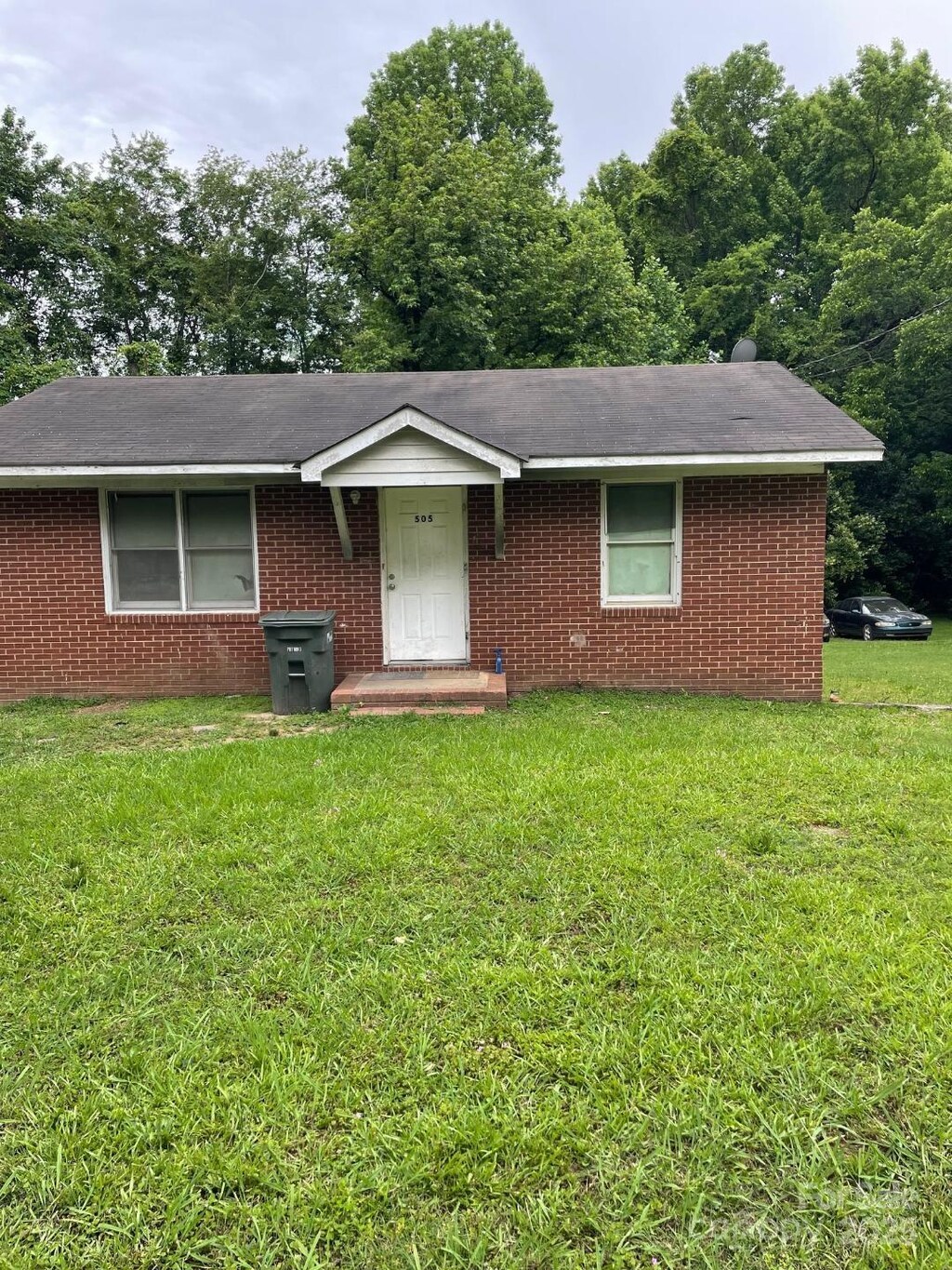 505 N Secrest Ave, Monroe, NC 28110 - single story home featuring a front lawn, brick siding, and roof with shingles