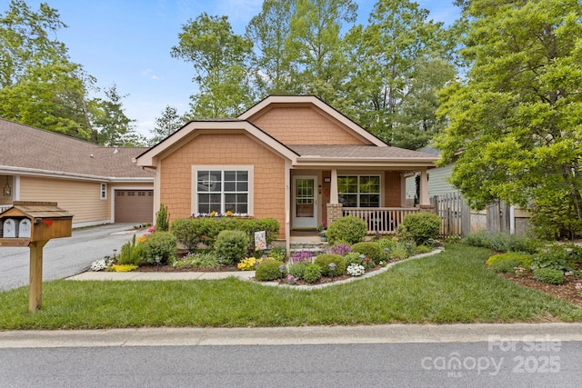40 Avonlea Ln, Flat Rock, NC 28731 - view of front of house featuring covered porch, a garage, and asphalt driveway