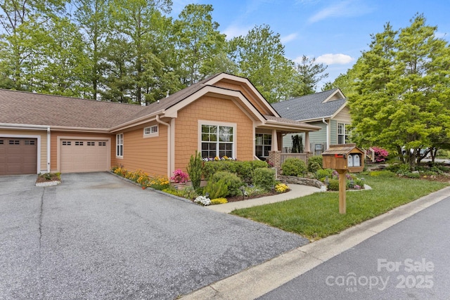 40 Avonlea Ln, Flat Rock, NC 28731 - ranch-style house featuring a garage, driveway, a front lawn, and roof with shingles