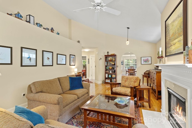 40 Avonlea Ln, Flat Rock, NC 28731 - living area featuring arched walkways, ceiling fan, light wood-style floors, a fireplace, and baseboards