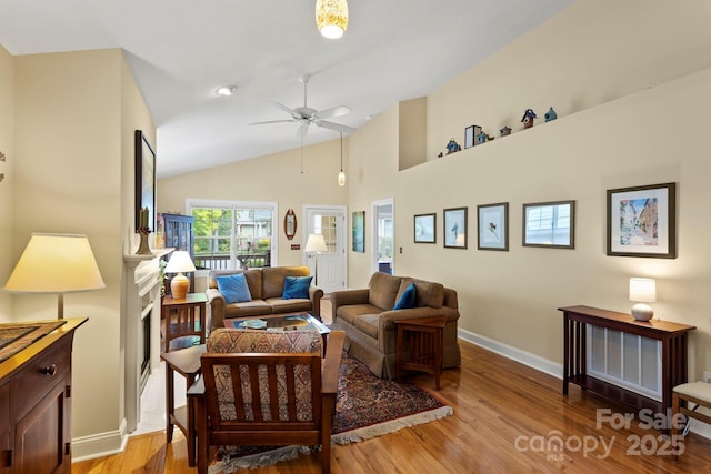 40 Avonlea Ln, Flat Rock, NC 28731 - living area featuring light wood-style floors, a ceiling fan, baseboards, a fireplace, and high vaulted ceiling