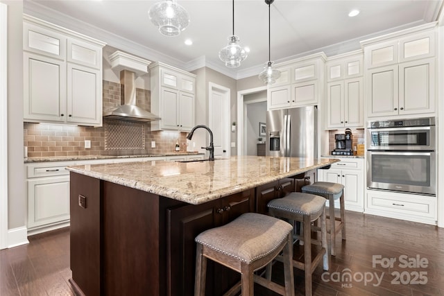 9125 Dylan Ridge Ct, Concord, NC 28027 - kitchen with appliances with stainless steel finishes, a sink, wall chimney exhaust hood, ornamental molding, and dark wood-style floors