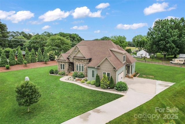 9125 Dylan Ridge Ct, Concord, NC 28027 - view of front of property featuring stone siding, concrete driveway, an attached garage, and roof with shingles