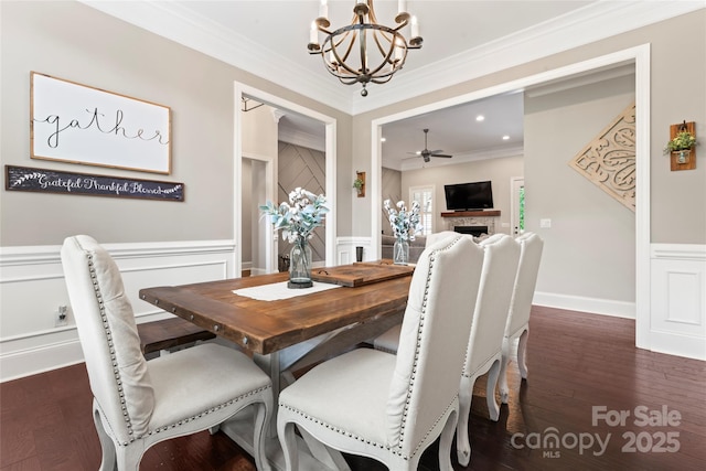 9125 Dylan Ridge Ct, Concord, NC 28027 - dining room with a chandelier, wainscoting, crown molding, a decorative wall, and a fireplace