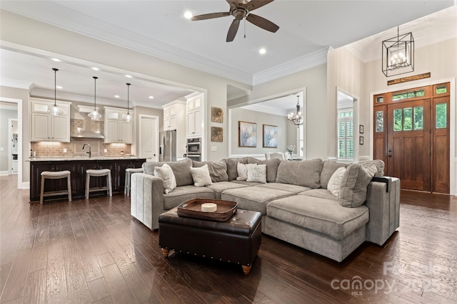 9125 Dylan Ridge Ct, Concord, NC 28027 - living area with recessed lighting, a chandelier, a ceiling fan, dark wood-style floors, and ornamental molding