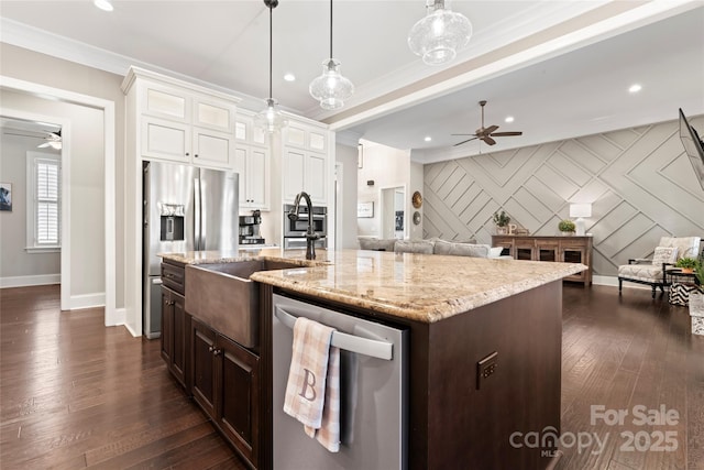 9125 Dylan Ridge Ct, Concord, NC 28027 - kitchen featuring appliances with stainless steel finishes, ceiling fan, baseboards, open floor plan, and crown molding