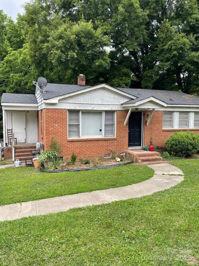 507 N Secrest Ave, Monroe, NC 28110 - ranch-style house featuring brick siding, a front yard, and a chimney