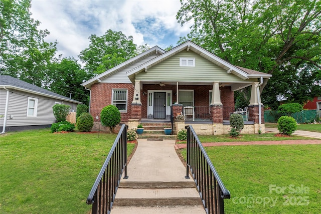 224 E Steele St, Salisbury, NC 28144 - view of front facade with brick siding, covered porch, and a front yard