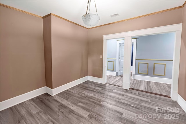 224 E Steele St, Salisbury, NC 28144 - spare room featuring crown molding, baseboards, and wood finished floors