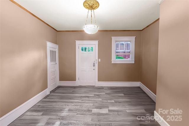 224 E Steele St, Salisbury, NC 28144 - entryway featuring wood finished floors, ornamental molding, and baseboards