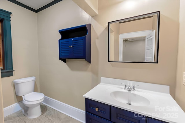 224 E Steele St, Salisbury, NC 28144 - bathroom featuring baseboards, toilet, vanity, and ceiling fan