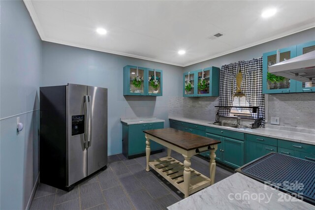 224 E Steele St, Salisbury, NC 28144 - kitchen with stainless steel fridge, green cabinets, backsplash, light countertops, and ornamental molding