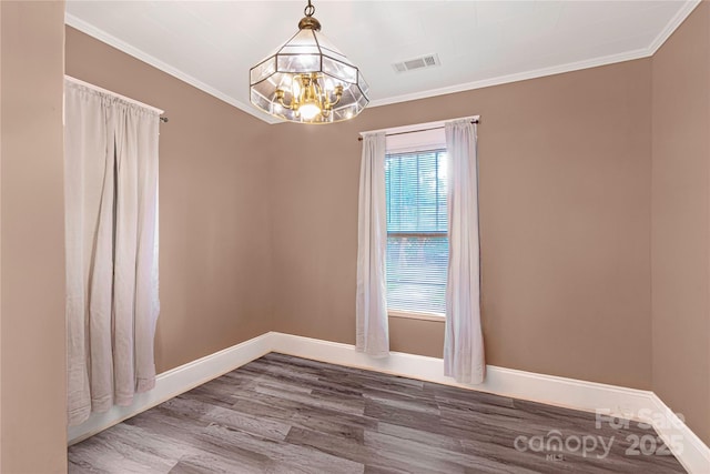 224 E Steele St, Salisbury, NC 28144 - unfurnished room featuring a chandelier, wood finished floors, crown molding, and baseboards