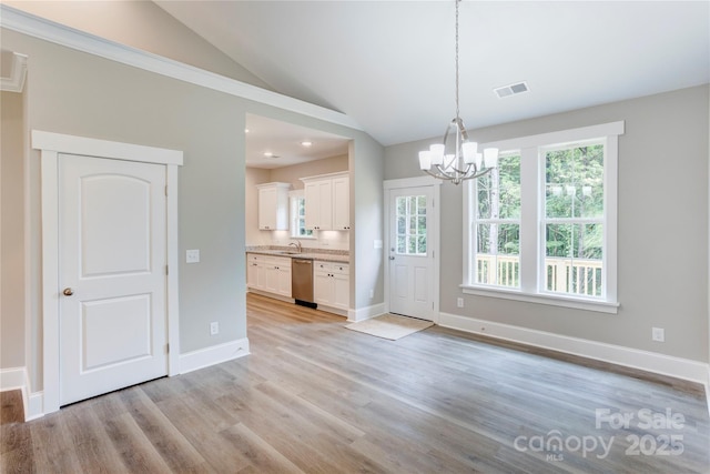 501 Old Speedway Dr NW Unit 1, Concord, NC 28027 - unfurnished dining area featuring a chandelier, a sink, lofted ceiling, light wood-style floors, and baseboards