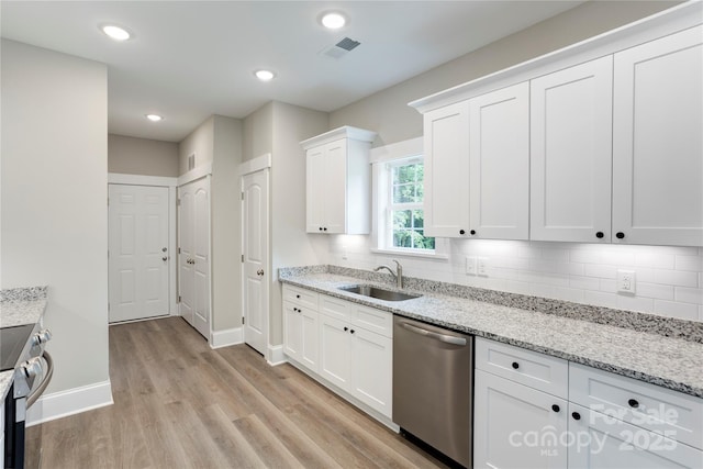 501 Old Speedway Dr NW Unit 1, Concord, NC 28027 - kitchen with appliances with stainless steel finishes, a sink, baseboards, light wood-style floors, and white cabinets