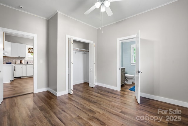 73 20th Ave SW, Hickory, NC 28602 - unfurnished bedroom featuring multiple windows, ornamental molding, dark wood finished floors, baseboards, and a closet