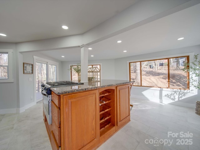 2143 Manawa Ln, Tega Cay, SC 29708 - kitchen with dark stone counters, recessed lighting, gas stove, a kitchen island, and baseboards