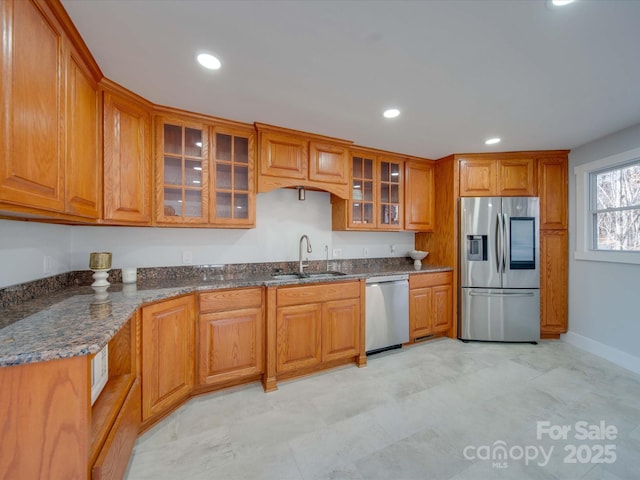 2143 Manawa Ln, Tega Cay, SC 29708 - kitchen featuring stainless steel appliances, a sink, brown cabinets, glass insert cabinets, and recessed lighting
