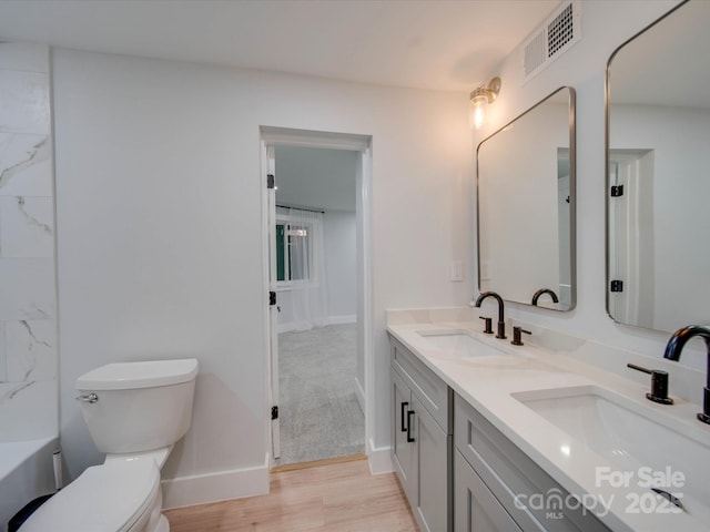 2143 Manawa Ln, Tega Cay, SC 29708 - bathroom with double vanity, toilet, baseboards, and wood finished floors