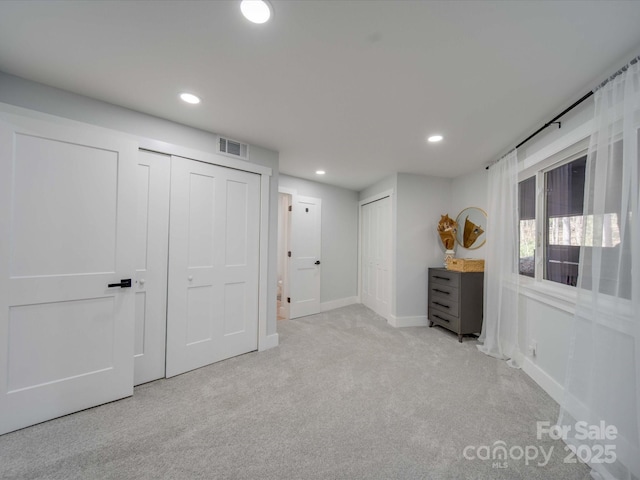 2143 Manawa Ln, Tega Cay, SC 29708 - unfurnished bedroom with two closets, carpet flooring, recessed lighting, and baseboards