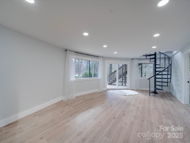 2143 Manawa Ln, Tega Cay, SC 29708 - unfurnished living room featuring stairway, wood finished floors, baseboards, and recessed lighting