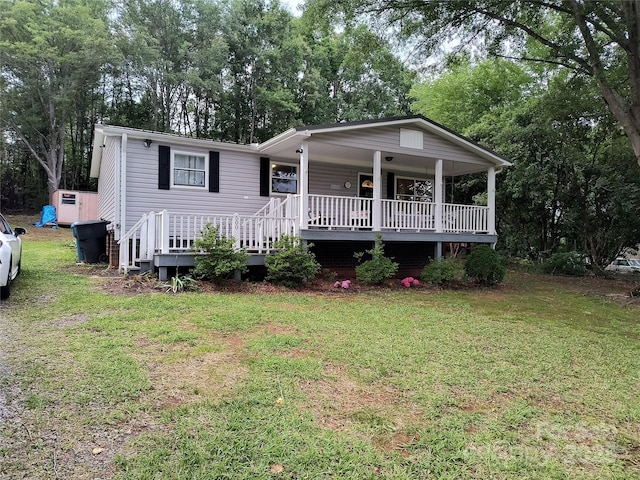 500 Bob Rollins Rd, Forest City, NC 28043 - manufactured / mobile home with a porch, a front yard, and view of scattered trees