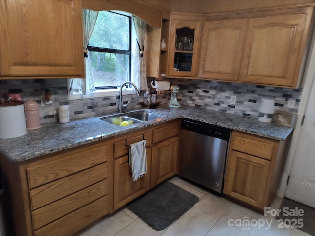 500 Bob Rollins Rd, Forest City, NC 28043 - kitchen featuring stainless steel dishwasher, a sink, tasteful backsplash, brown cabinetry, and light stone countertops