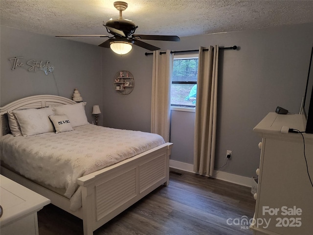 500 Bob Rollins Rd, Forest City, NC 28043 - bedroom with a textured ceiling, dark wood-type flooring, baseboards, and ceiling fan