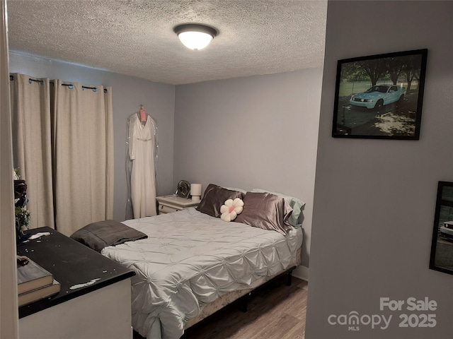 500 Bob Rollins Rd, Forest City, NC 28043 - bedroom featuring wood finished floors and a textured ceiling