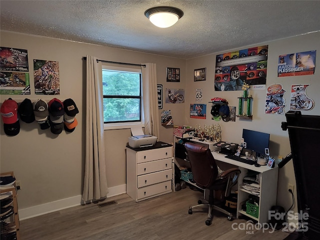 500 Bob Rollins Rd, Forest City, NC 28043 - office featuring a textured ceiling, wood finished floors, and baseboards