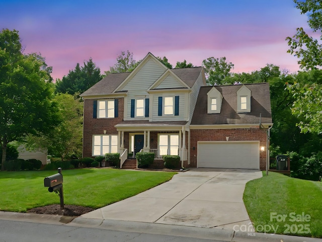 2821 Providence Spring Ln, Charlotte, NC 28270 - view of front of property featuring brick siding, driveway, a front yard, covered porch, and a garage