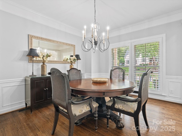 2821 Providence Spring Ln, Charlotte, NC 28270 - dining space featuring a chandelier, crown molding, wainscoting, a decorative wall, and wood finished floors