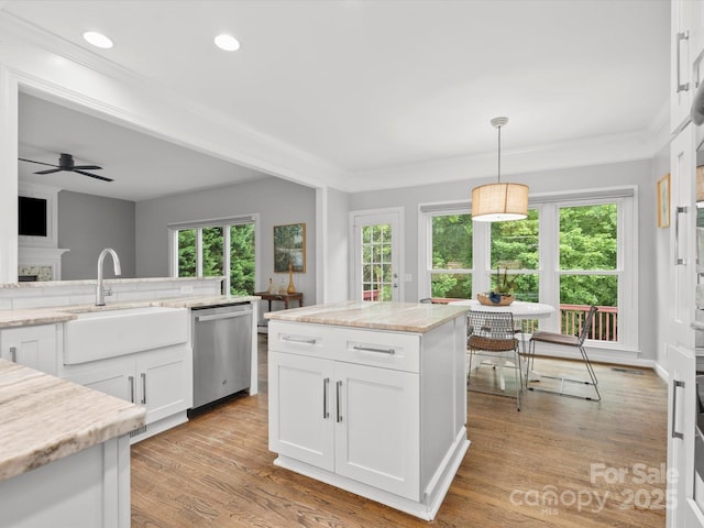 2821 Providence Spring Ln, Charlotte, NC 28270 - kitchen with stainless steel dishwasher, a sink, white cabinets, a ceiling fan, and recessed lighting