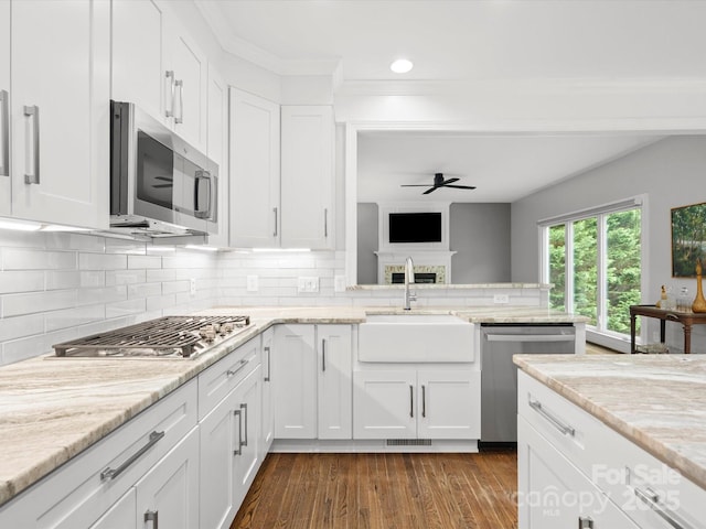 2821 Providence Spring Ln, Charlotte, NC 28270 - kitchen with stainless steel appliances, a sink, a ceiling fan, white cabinets, and tasteful backsplash