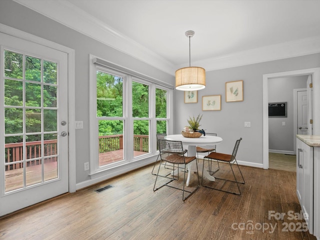 2821 Providence Spring Ln, Charlotte, NC 28270 - dining space with wood finished floors, baseboards, and crown molding