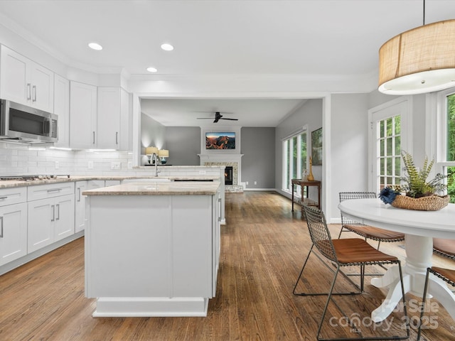 2821 Providence Spring Ln, Charlotte, NC 28270 - kitchen featuring appliances with stainless steel finishes, a stone fireplace, recessed lighting, a sink, and ceiling fan