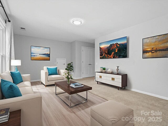 2821 Providence Spring Ln, Charlotte, NC 28270 - living room featuring baseboards and light wood-style floors