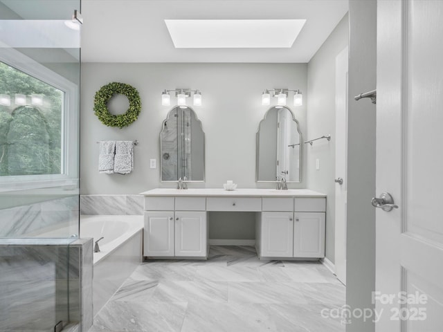 2821 Providence Spring Ln, Charlotte, NC 28270 - full bathroom with a skylight, double vanity, a bath, and marble finish flooring